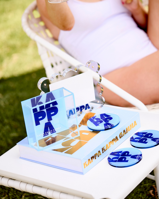 a woman sitting in a chair next to a book